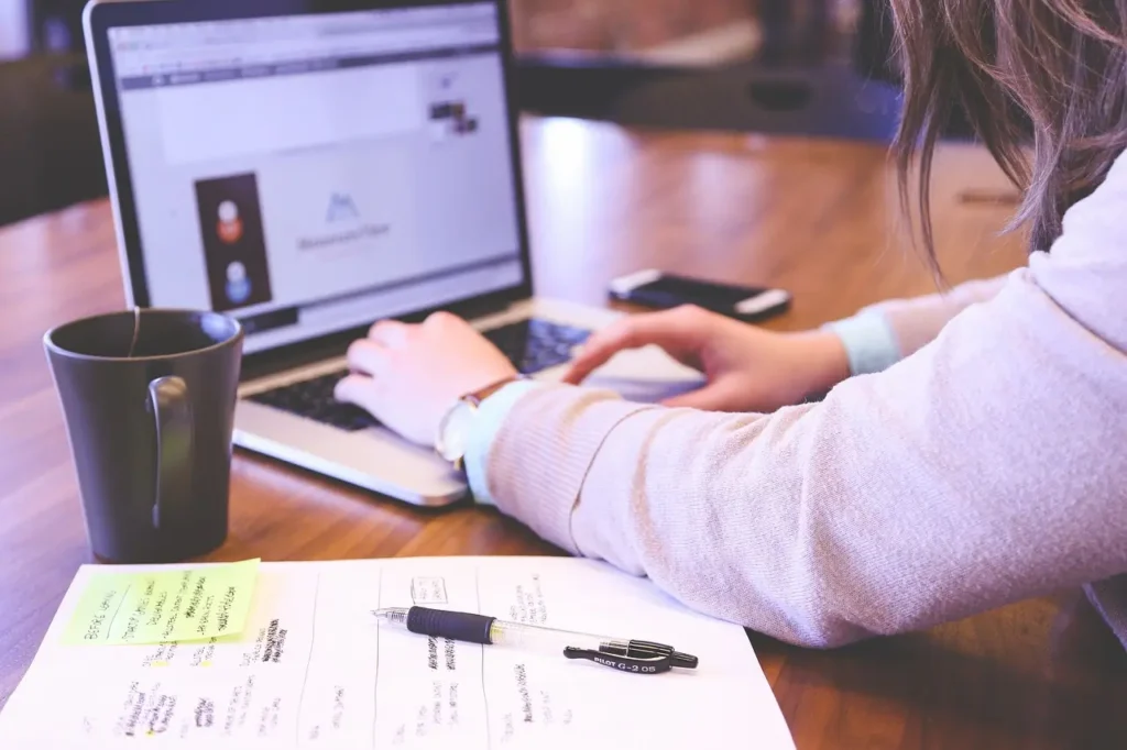Clear screen mockups on a laptop on a desk and a monitor behind the laptop.